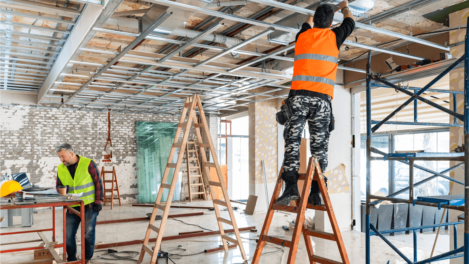 Workers installing ceiling framework