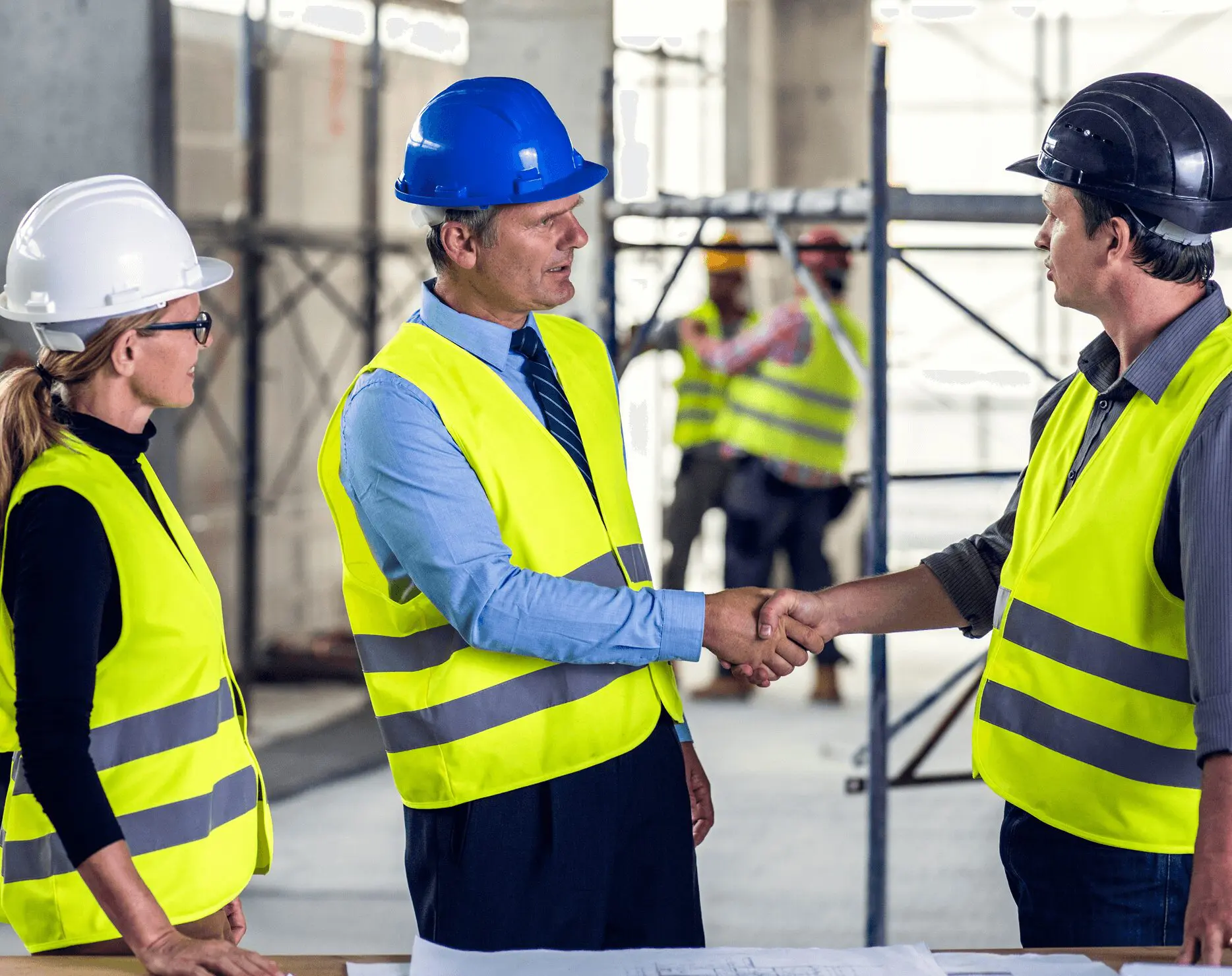 Construction workers shaking hands at site