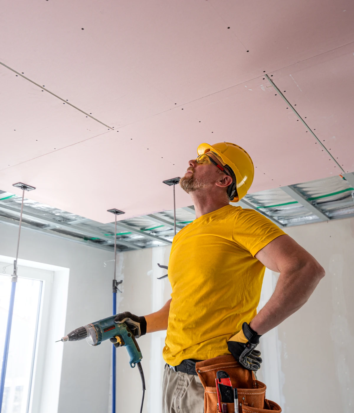 Construction worker inspecting ceiling installation